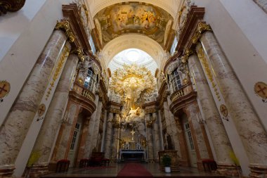 VIENNA, AUSTRIA - JULY 2018 : Altar at St. Charles Church, Karlsplatz in Vienna, Austria on July 15, 2018. Golden piece above altar symbolizing Yahweh,  national god of Israel clipart