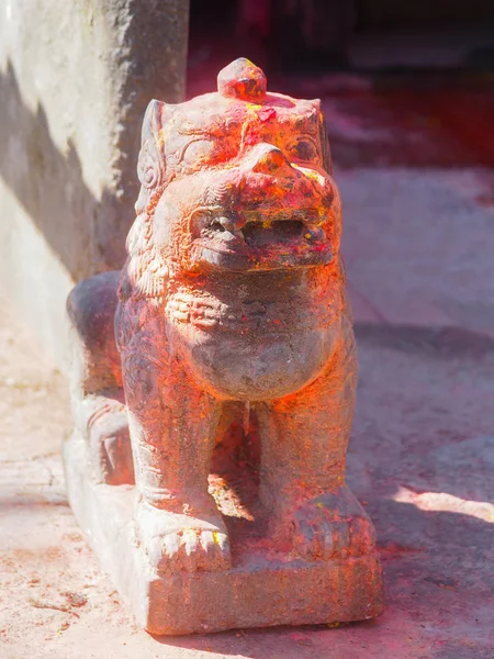 Mythological lion with red pigment guarding shrine at Kali Temple