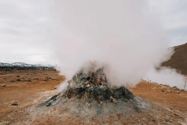 Fumarole evacuating pressurized hot sulfurous gases from volcanic activity in the geothermal area of Hverir Iceland near Lake Myvatn
