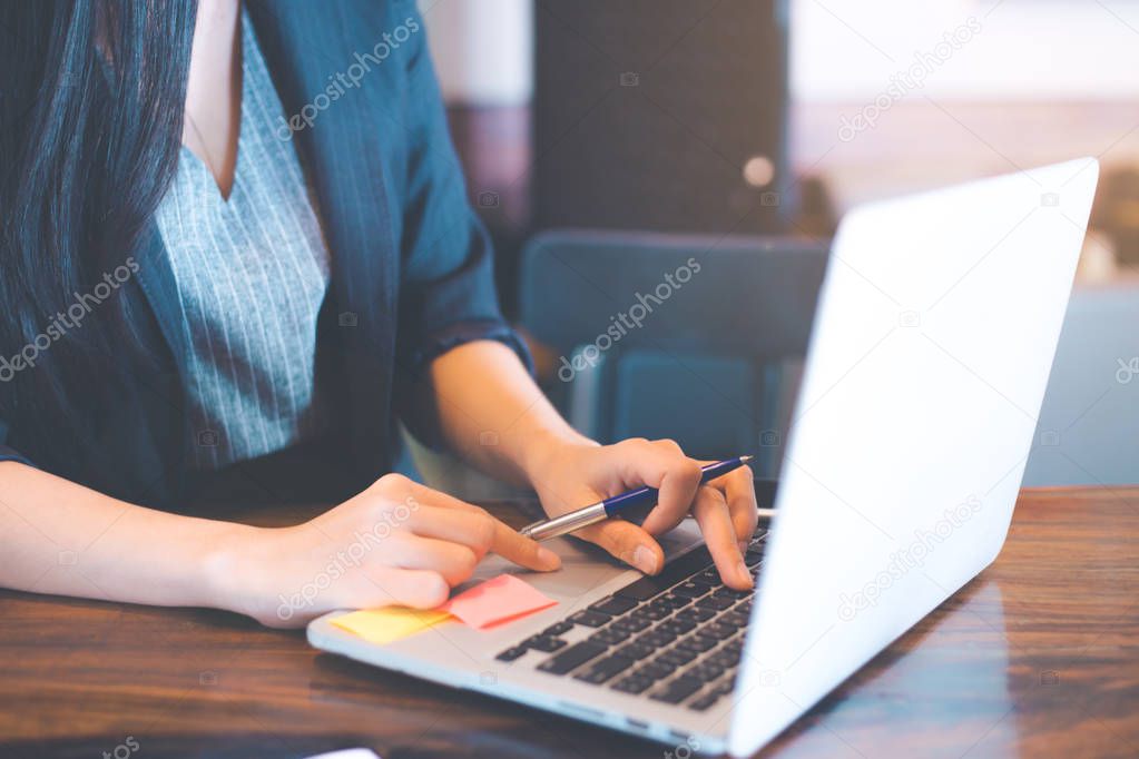 Business women are using a laptop computer in the office.