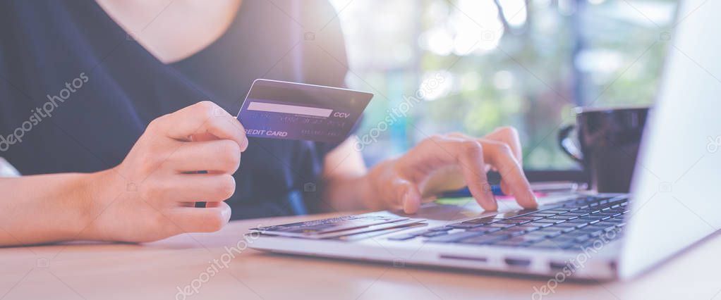Business women hand use credit cards and laptop computers to sho