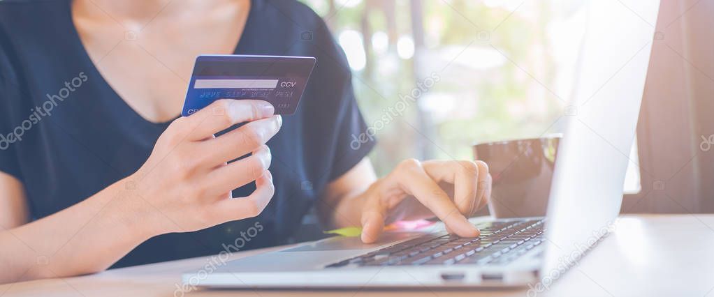 Business women use credit cards and laptop computer.