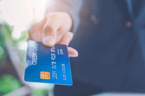 Businessmen send blue credit cards for payment of goods.