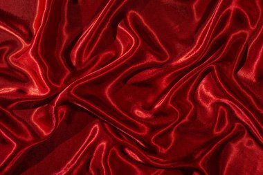 Arka plan kırmızı saten kumaş. Parlak ipek zemin. 