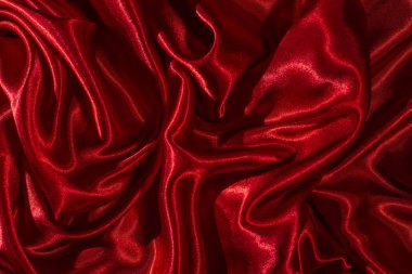 Arka plan kırmızı saten kumaş. Parlak ipek zemin. 