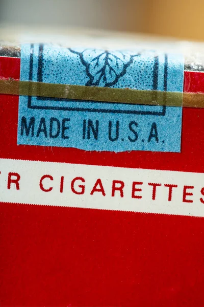 Made in USA label. Vintage packet of cigarettes produced in the USA. Banderole on top of the pack.  Red package. Close shot of filter cigarettes pack. US tax exempt for use outside USA.