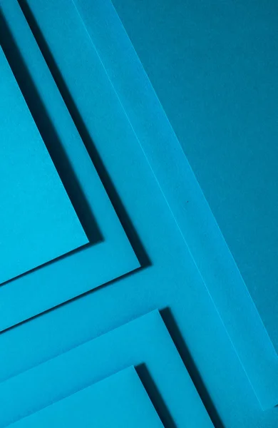 Blue paper material design. Geometric unicolour shapes. Wallpaper design background.