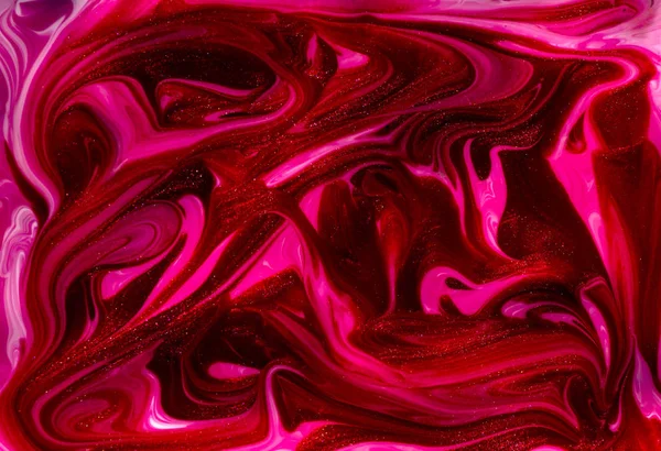 Bright red and pink marbling texture. Abstract colorful background. Multicolored pattern in liquid. Creative background with abstract painted waves, handmade surface. Liquid marble paint.