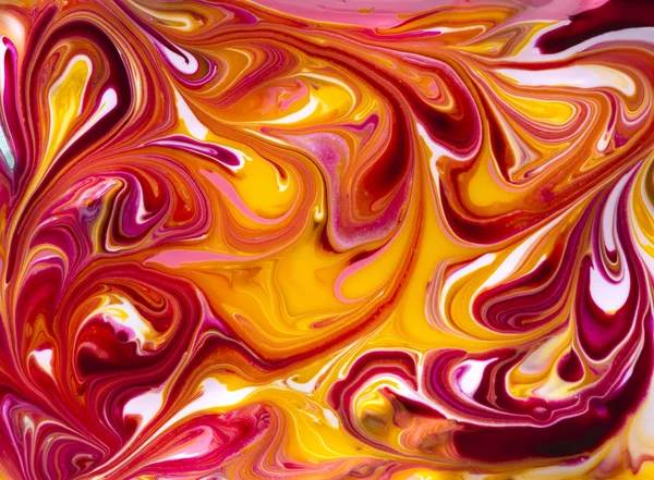 Bright red and yellow marbling texture. Abstract colorful background. Multicolored pattern in liquid. Creative background with abstract painted waves, handmade surface. Liquid marble paint.