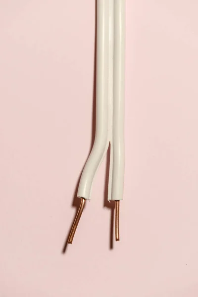 ピンクのパステル調の背景に電気ケーブル 銅線を広げた シンプルな電気的背景 — ストック写真