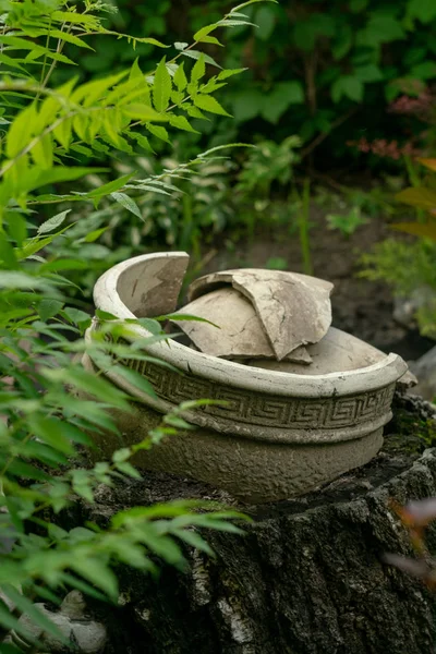 An imitation of ancient Greek ceramics in the garden. Clay pot with geometric ornament