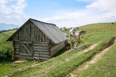 Ormanlığın önündeki eski küçük evler. Gezinti Yaşam Tarzı konsepti dağ manzarası. Ukrayna, Karpatlar 'ın dağlarına yolculuk
