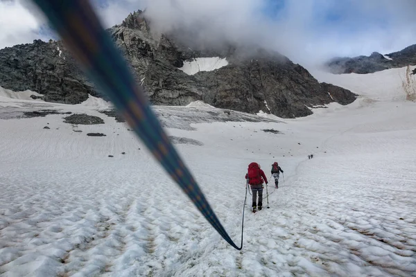 Tým Alpinistů Napjatý Provazem Obklopený Skalnatými Horami Mlze Rakouských Alpách — Stock fotografie