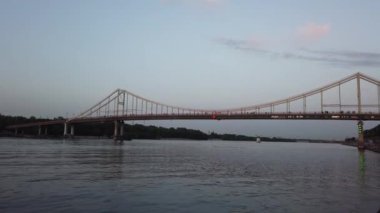 Trukhaniv adası ve Ukrayna 'nın Kyiv şehrindeki Dnipro nehri üzerindeki yaya köprüsü manzarası. Dinyeper, Avrupa 'nın en büyük nehirlerinden biridir ve Ukrayna' nın en uzun nehridir.