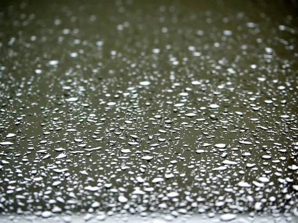 The scattered rain drops on the mirror that shot from the inside of the house