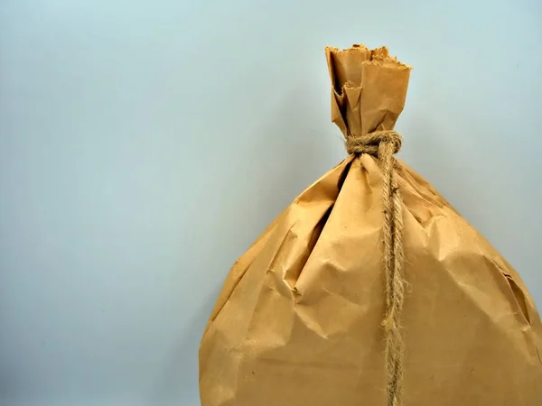 Close up shot on the brown paper bag with tied rope with white background