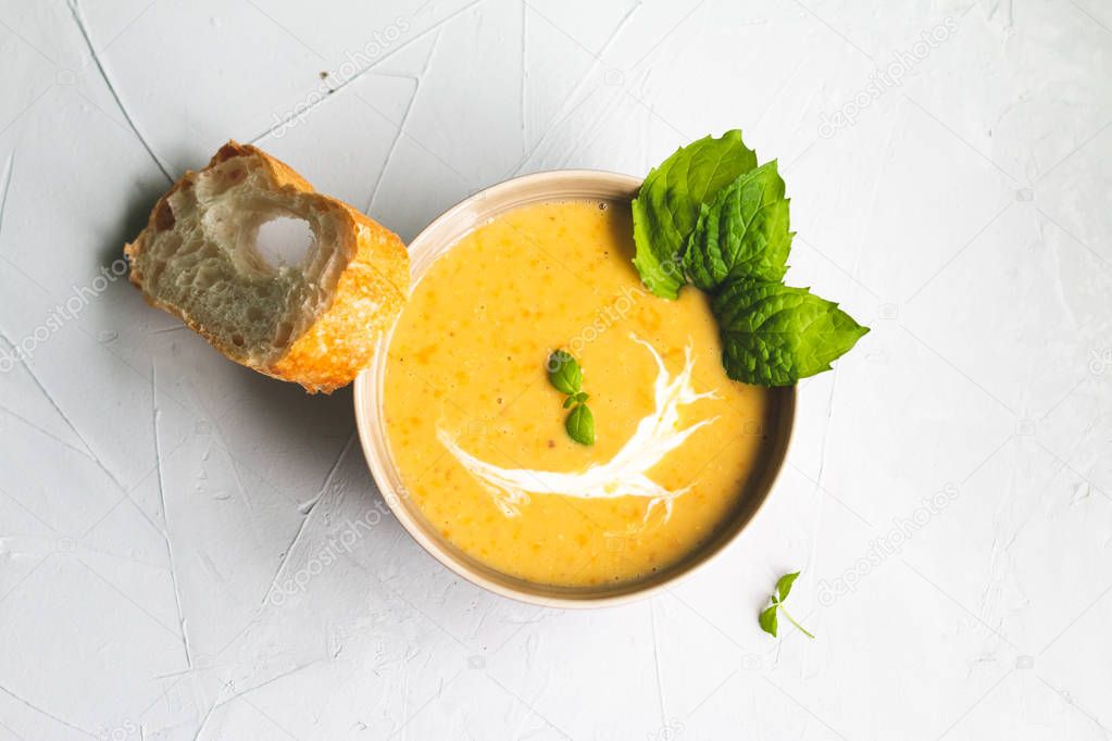 lentil soup on a grey background with mint leaf and space for text