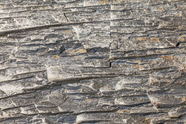 Seamless stone texture in a mountain gorge. Photo shows a stone texture. The texture of the stone, I photographed in nature - in the mountains in the canyons. A variety of shapes, colors and tones create a variety of patterns.