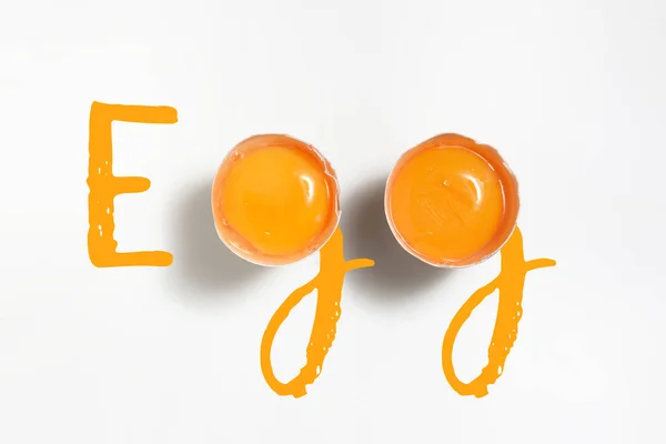 Word Egg Written Egg Yolks White Table — Stock Photo, Image