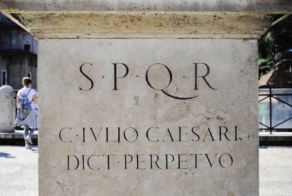 Latin inscription on the statue of Gaius Julius Caesar at the imperial forums of ROME. (translate: Gaius Julius Caesar, perpetual dictator). Gaius Julius Caesar was a Roman politician and military general. Rome, Italy