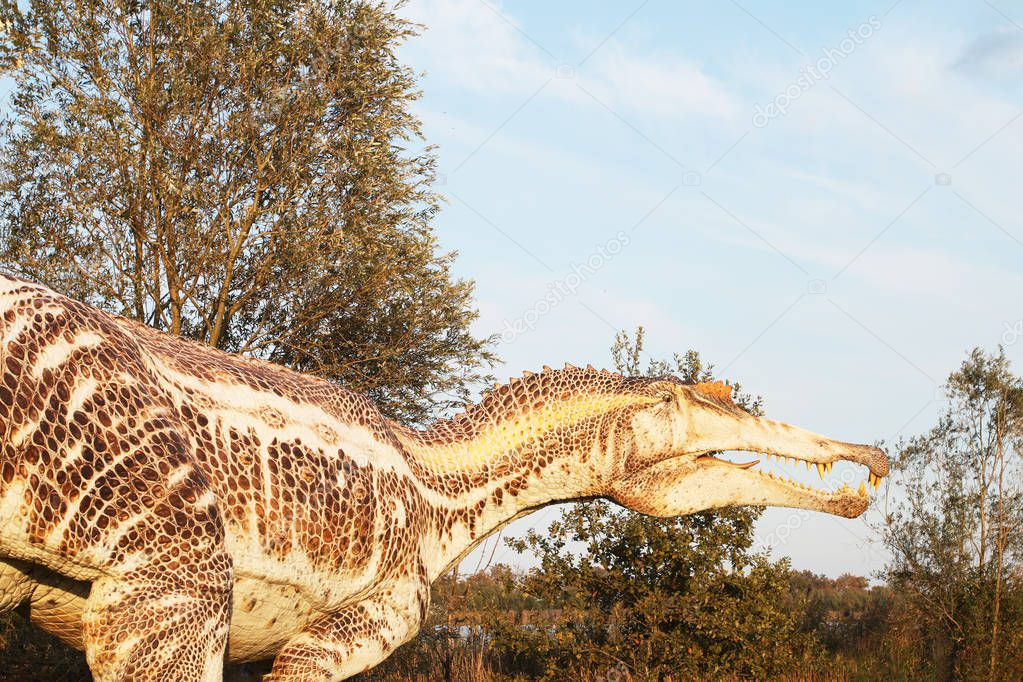 realistic copy of spinosaur in a natural environment