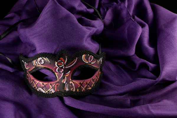 Mask on the purple fabric