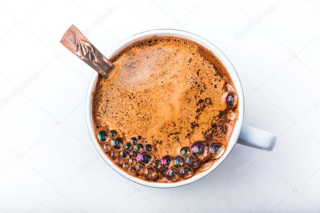Close up view of a bubbles in a white coffee mug