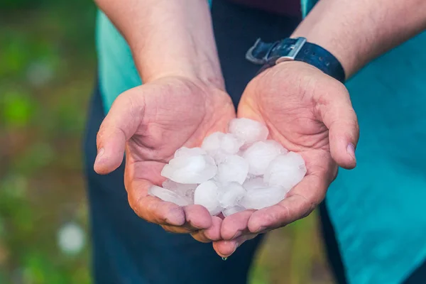 Man hand holding a hail after hailstorm — Stock Photo, Image