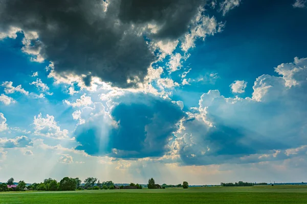 Cumulus storm clouds with light rays running across the sky