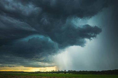 Supercell storm clouds with intense tropic rain clipart
