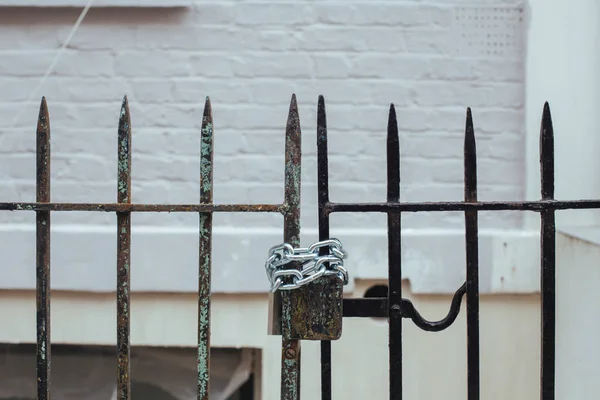 Chained padlock on the gate of a house in the Notting Hill, London, UK