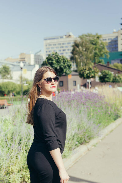Close up portrait of a woman in a city park on a warm sunny day
