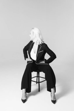 Siyah bir elbiseyle sarışın bir kadının portresi