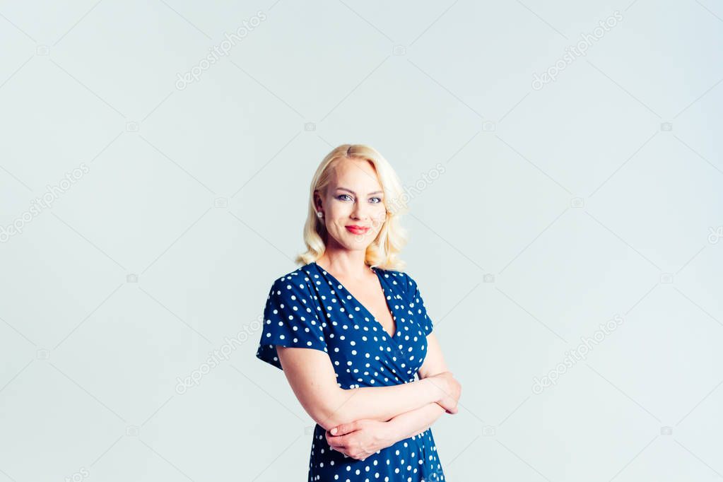 Portrait of a blond woman in a dark blue dress