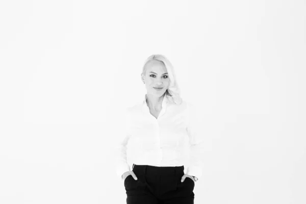 Portrait of a blonde woman in a white shirt and black pants — Stock Photo, Image