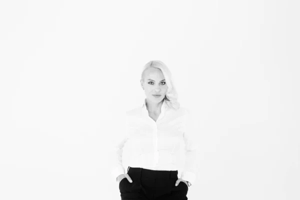 Portrait of a blonde woman in a white shirt and black pants — Stock Photo, Image