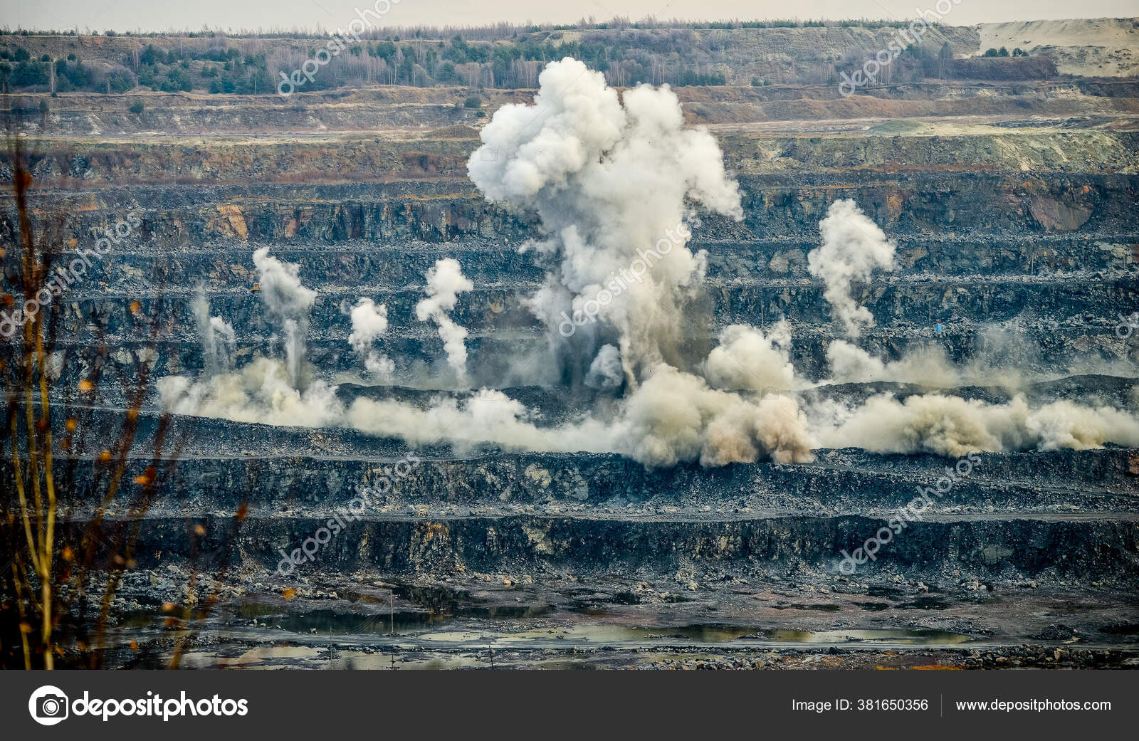 Production Granite stone mining by quarry machines Stock Photo by