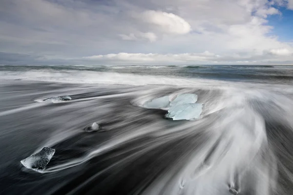 アイスランド ダイアモンド ビーチ ラグーン氷河氷山ブラック ダイヤモンド ビーチ アイスランドで海で抽象的な形を形成します 嵐の日の夕日の素晴らしい風景 — ストック写真