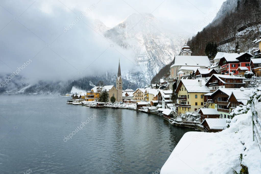 The Christmas village of Hallstatt in the Austrian Alps, in winter time covered with snow. Scenic postcard view of famous Hallstatt lakeside town in Austria.