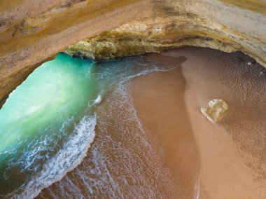 Famous natural cave at Benagil beach in Algarve Portugal.  landscape at one of the main holiday destinations in europe. Summer tourist attraction. Drone aerial view. clipart