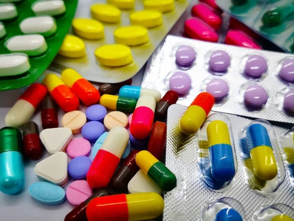 Birçok renkli hap, tablet ve kapsül tıbbi ilaç, beyaz arka plan üzerinde izole. Seçici odak.