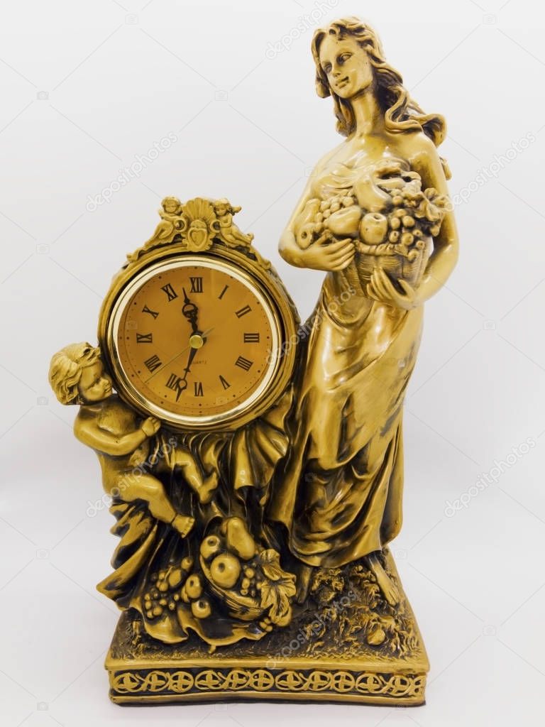 Bronze desk clock, woman holding a fruit basket and  little boy sitting next to clock. Isolated on white background with clipping path.