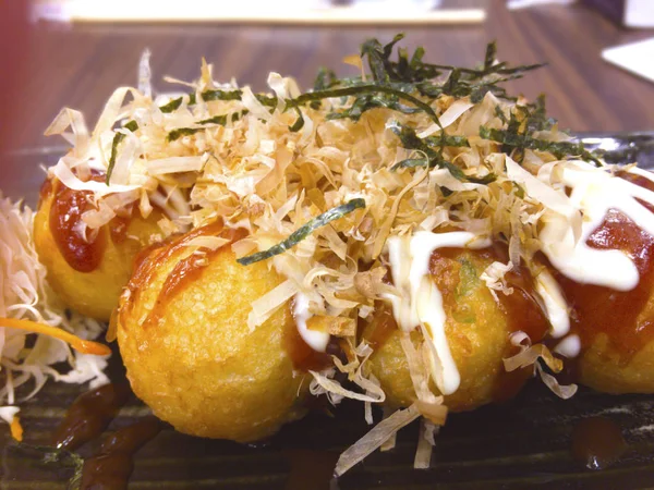 Bir Japon çerezim un, patatesten yapılan şal ahtapot parçalarını içeren küçük yuvarlak toplar şeklinde Takoyaki 