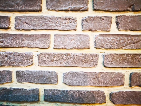 Home decoration concept and abstract background.Many brown brick blocks with white cement. Closeup view of brick blocks wall. The wall texture and background for wall design. Texture of brown brick blocks wall and copy space.