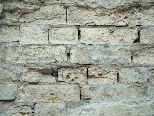 Старая разрушенная кирпичная стена, вид из окна. Кирпичная стена с обработанной штукатуркой. Текстура кладки. Серый фон поверхности. Серая винтажная стеновая структура . — стоковое фото