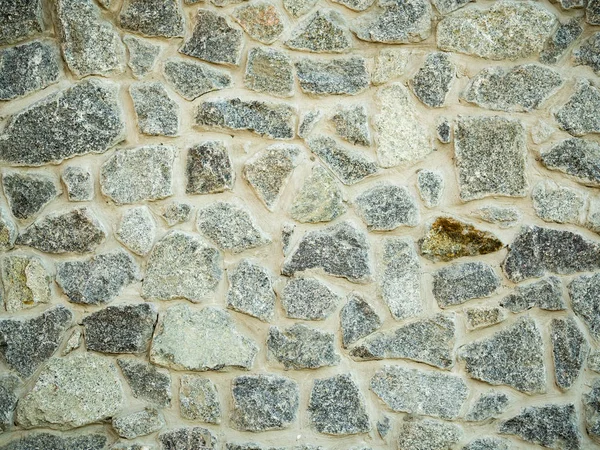 Détail du mur de pierre grise. Vue rapprochée sur la surface des parois rocheuses. Contexte abstrait. Texture de mur en pierre. Modèle de bloc gris . — Photo