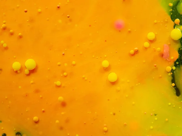 Bubbles on yellow orange background. Close up macro shot. Blurred background. Selective soft focus. Paint splashes and spots, abstract background. Pattern of abstract universe.