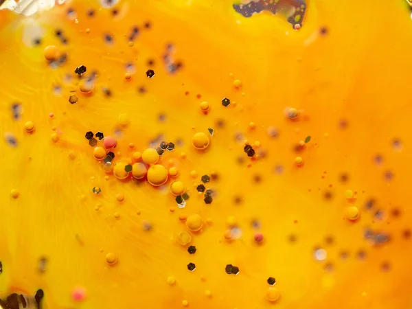 Abstract yellow orange background. Close up macro shot. Blurred background. Selective soft focus. Multicolour spheres and hexagons in orange universe. Abstract colorful pattern.