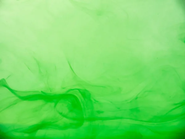 Ondas acrílicas abstratas em líquido. Vista de perto. Fundo desfocado. A tinta verde caiu na água, num padrão abstrato. Nuvens de acrílico misturando com água, fundo abstrato para papel de parede e banner . — Fotografia de Stock