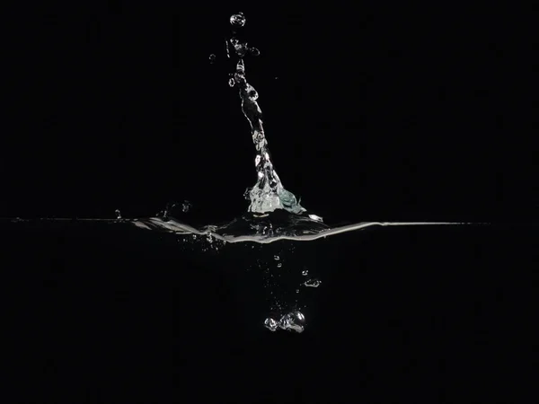 Water splash, bubbles and rippling surface isolated on black background, close up view. Background for overlays design, screen blending mode layer. Perfect for compositing into your shots.